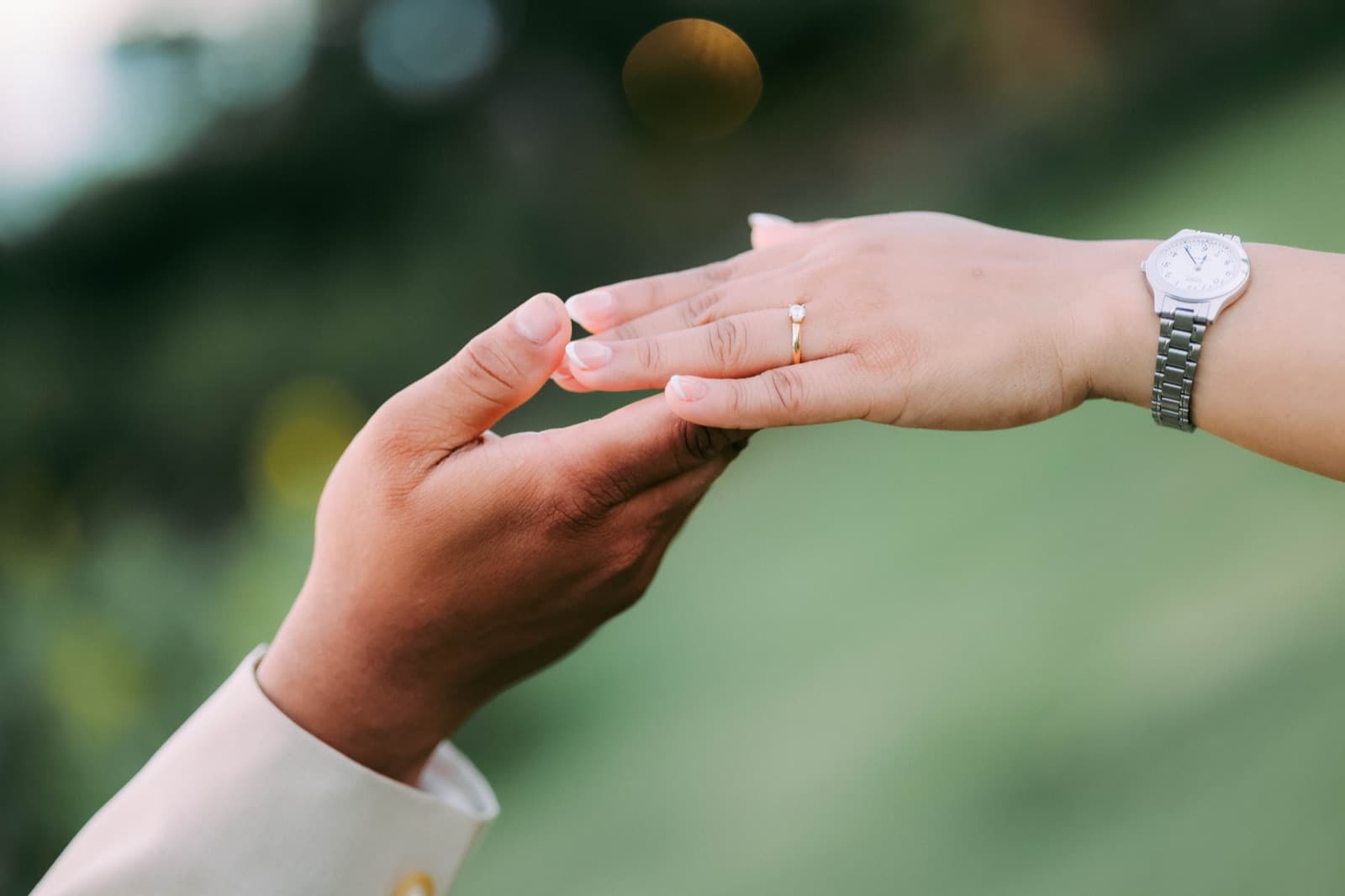 A quiet detail — hands and rings