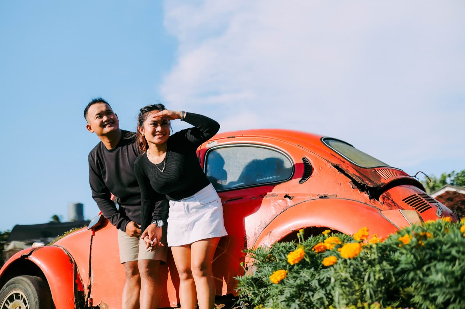 A candid laugh by the vintage car