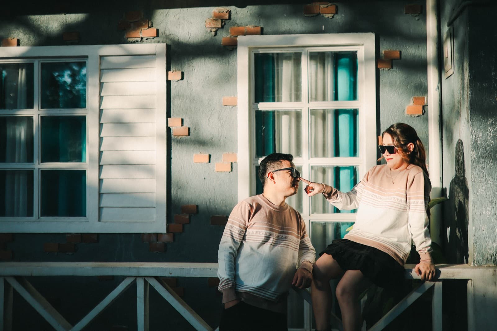 Laughing on the balcony rail