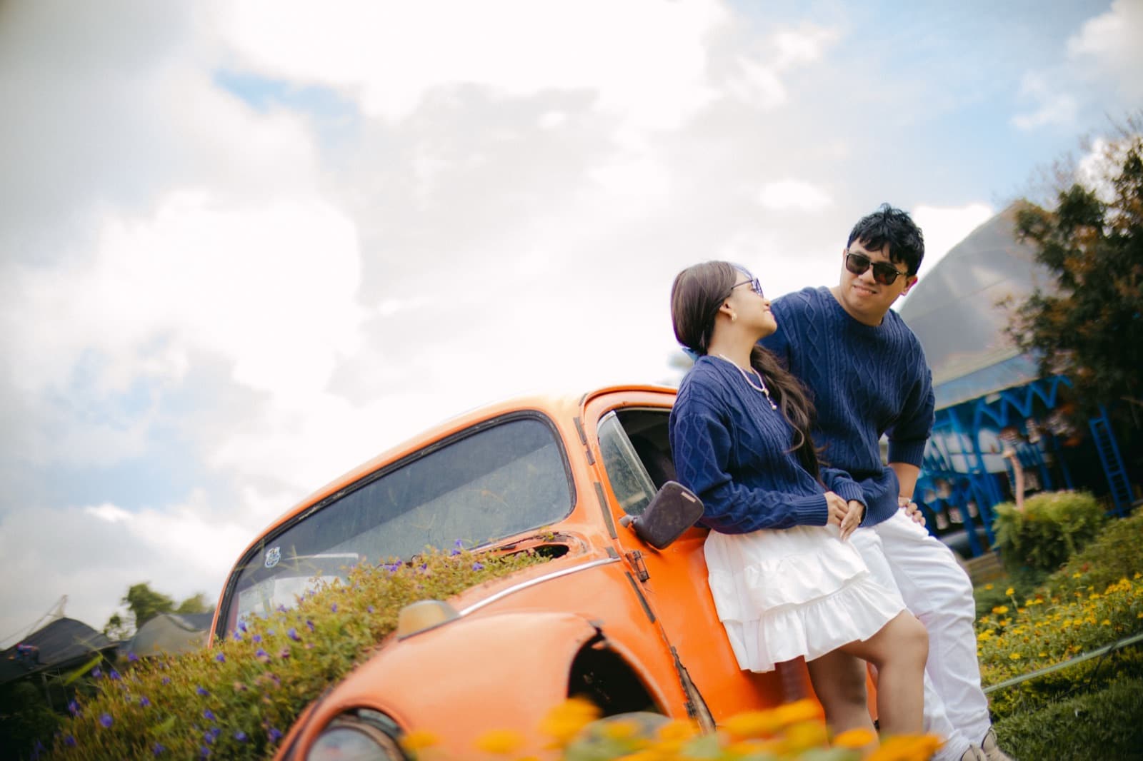 By the vintage orange car