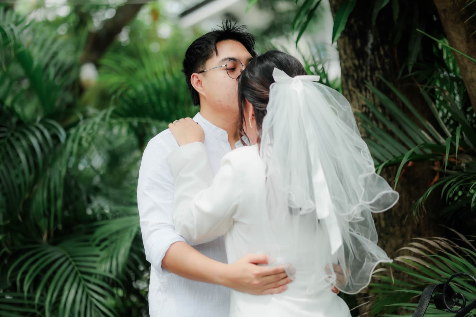 A kiss, veil catching the wind